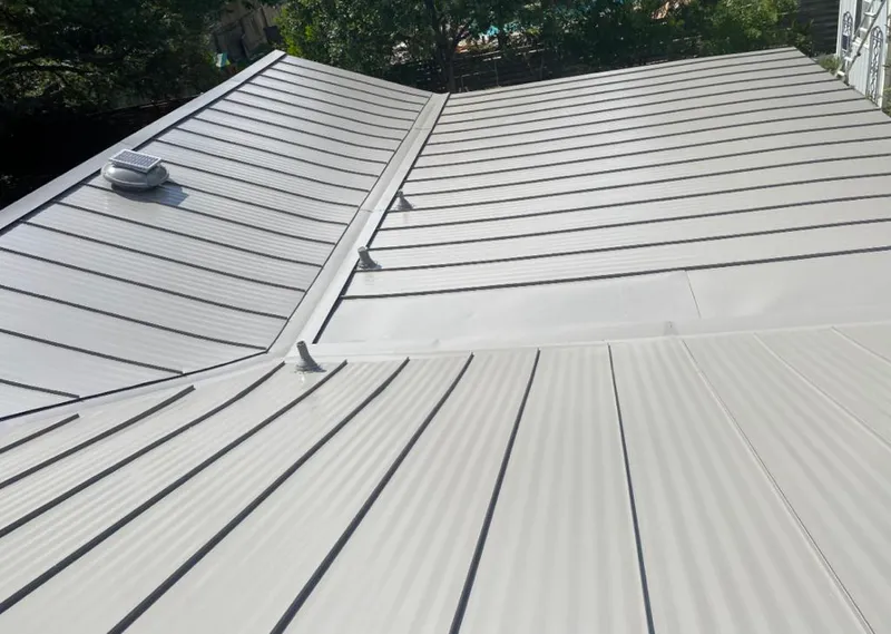 Solar attic fan installed on a metal roof for Roof Ventilation in Starke